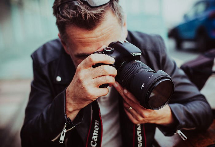 Man taking photo with a Canon camera