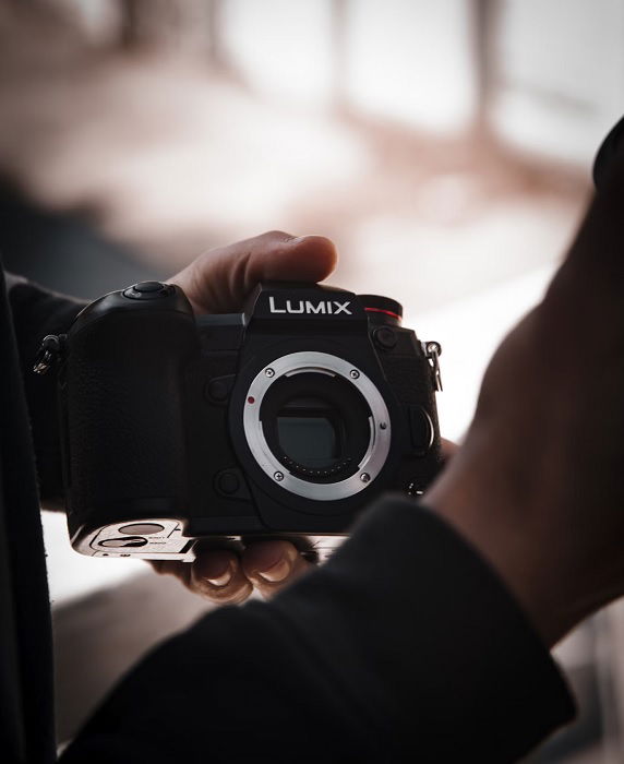 Someone holding a Panasonic Lumix Micro Four Thirds camera