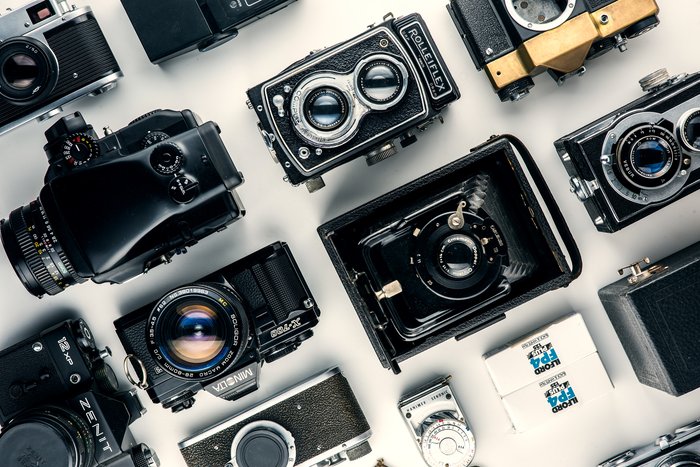 Photo by Alex Andrews from Pexels Various cameras laid out on a table
